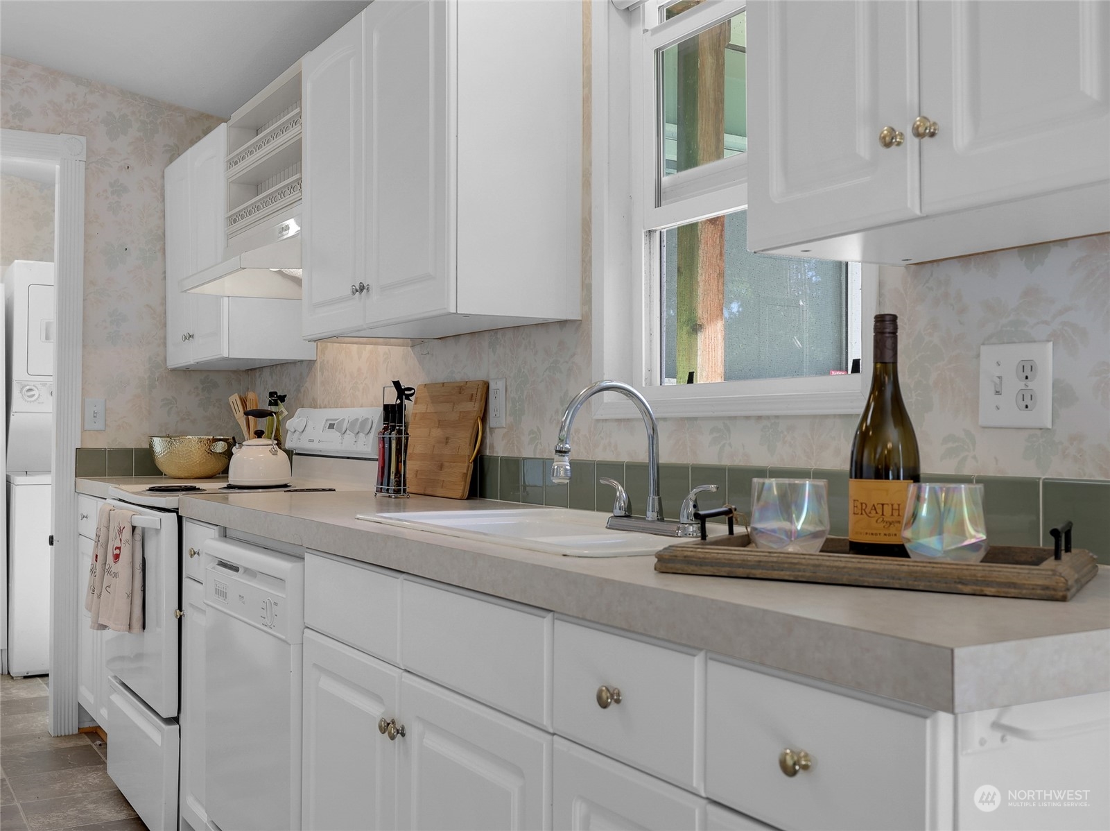 30511 Stackpole Lane Ocean Park, WA 98640 - Photo 16 of 40 a kitchen with white cabinets and sink