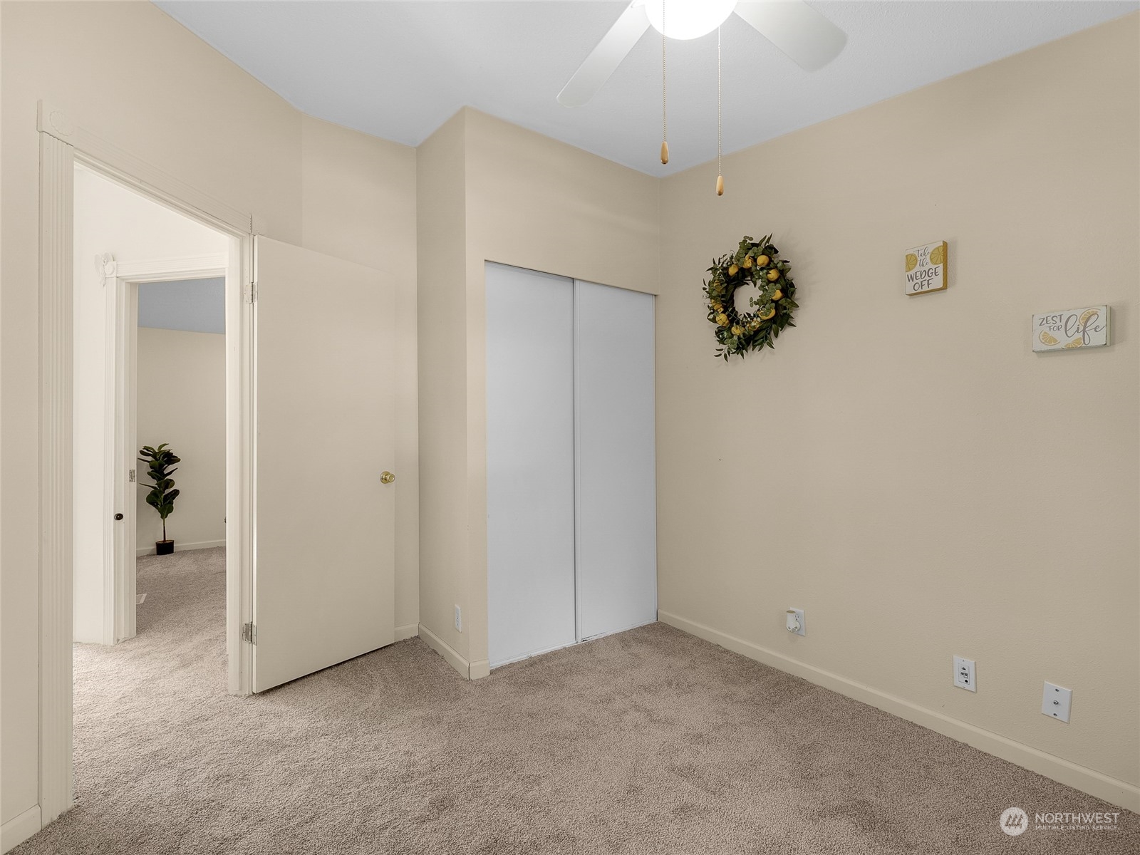 30511 Stackpole Lane Ocean Park, WA 98640 - Photo 21 of 40 an empty room with a chandelier fan and wooden floor