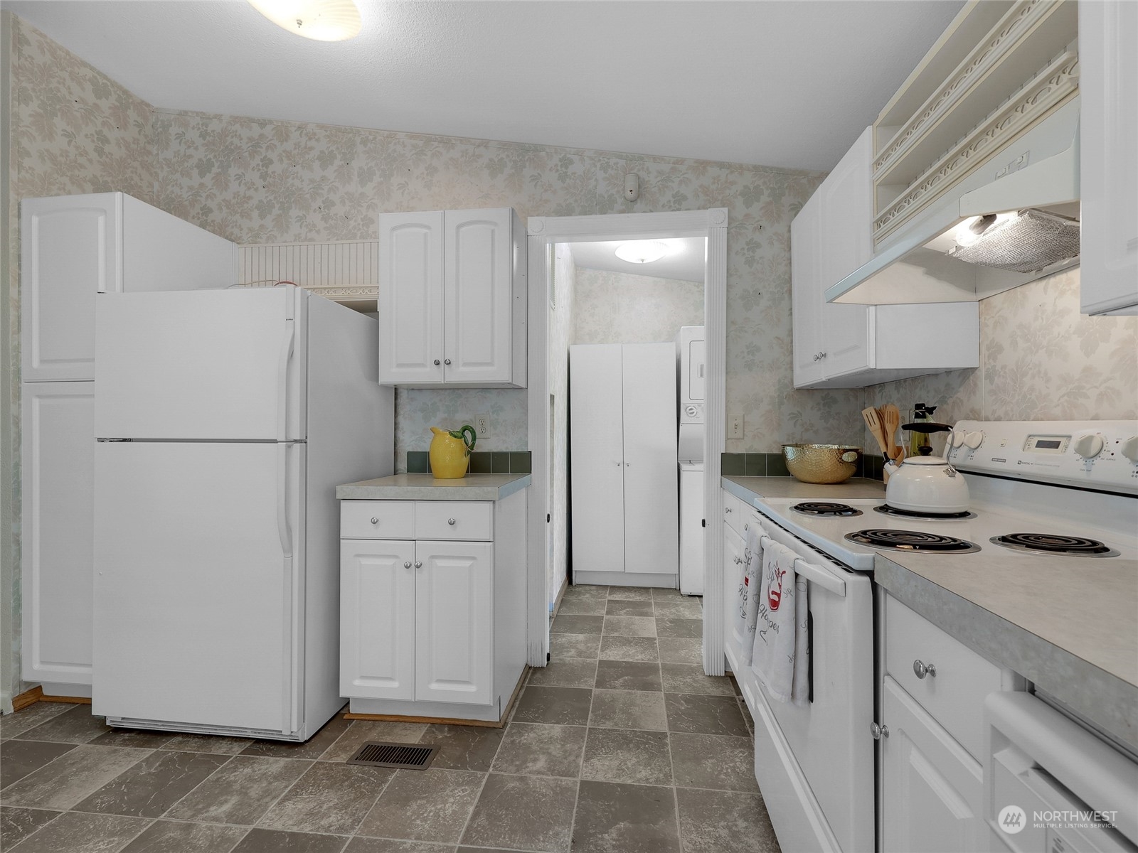 30511 Stackpole Lane Ocean Park, WA 98640 - Photo 25 of 40 a kitchen with white cabinets and refrigerator