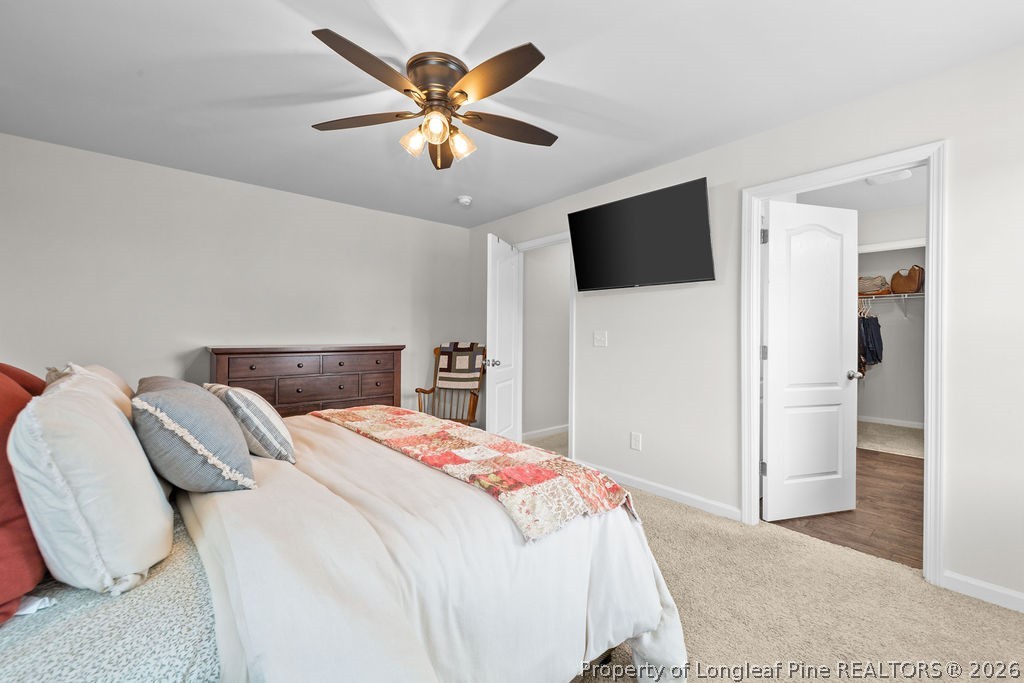 81 Merlin Court Godwin, NC 28344 - Photo 17 of 34 a bedroom with a bed and a flat screen tv