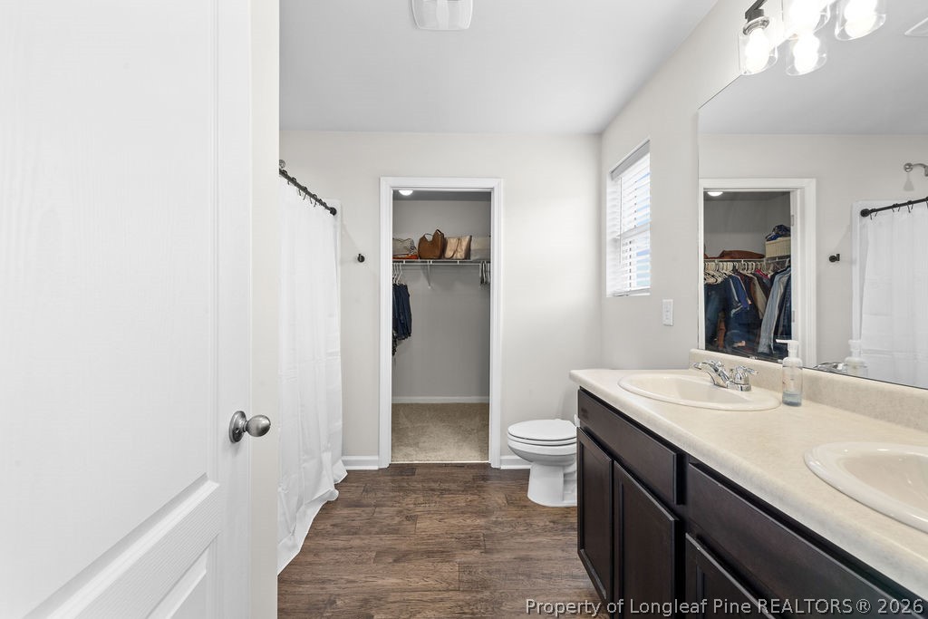 81 Merlin Court Godwin, NC 28344 - Photo 18 of 34 a bathroom with a sink a toilet and shower
