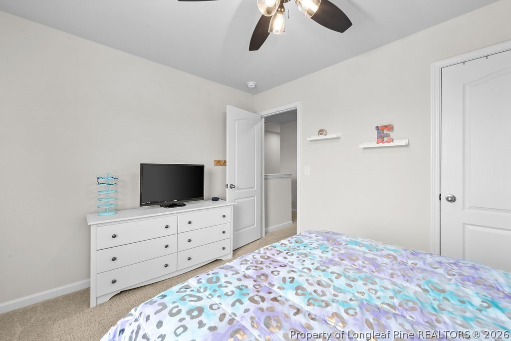 81 Merlin Court Godwin, NC 28344 - Photo 21 of 34 a bedroom with a bed and a flat tv screen on the dresser