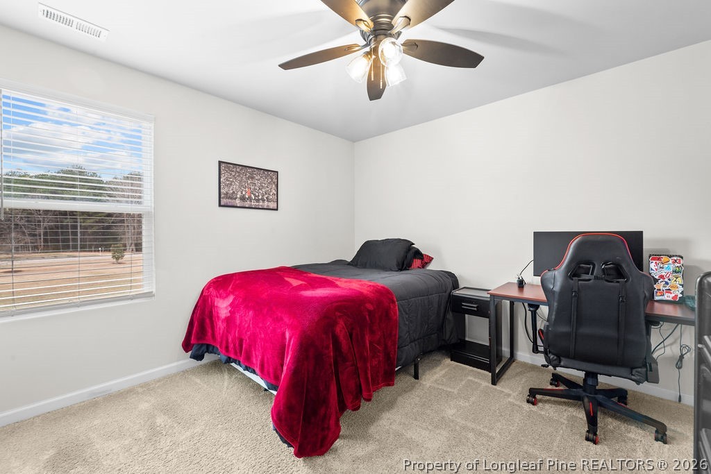 81 Merlin Court Godwin, NC 28344 - Photo 22 of 34 a bedroom with a bed and a chandelier