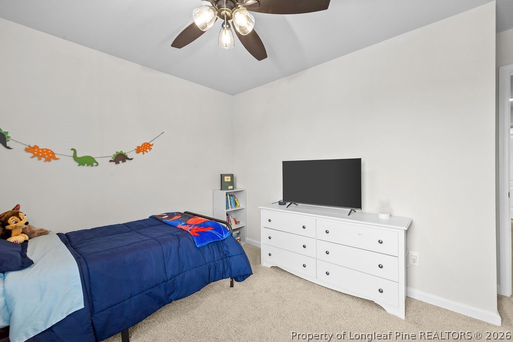 81 Merlin Court Godwin, NC 28344 - Photo 25 of 34 a bedroom with a bed and flat screen tv