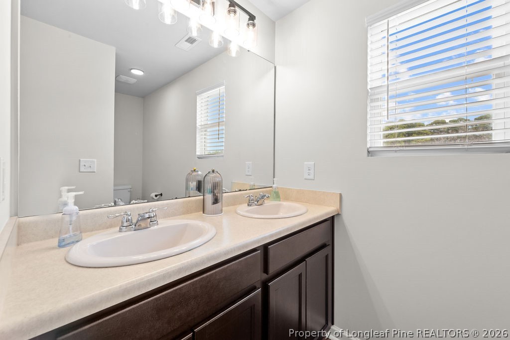 81 Merlin Court Godwin, NC 28344 - Photo 26 of 34 a bathroom with a sink and a mirror