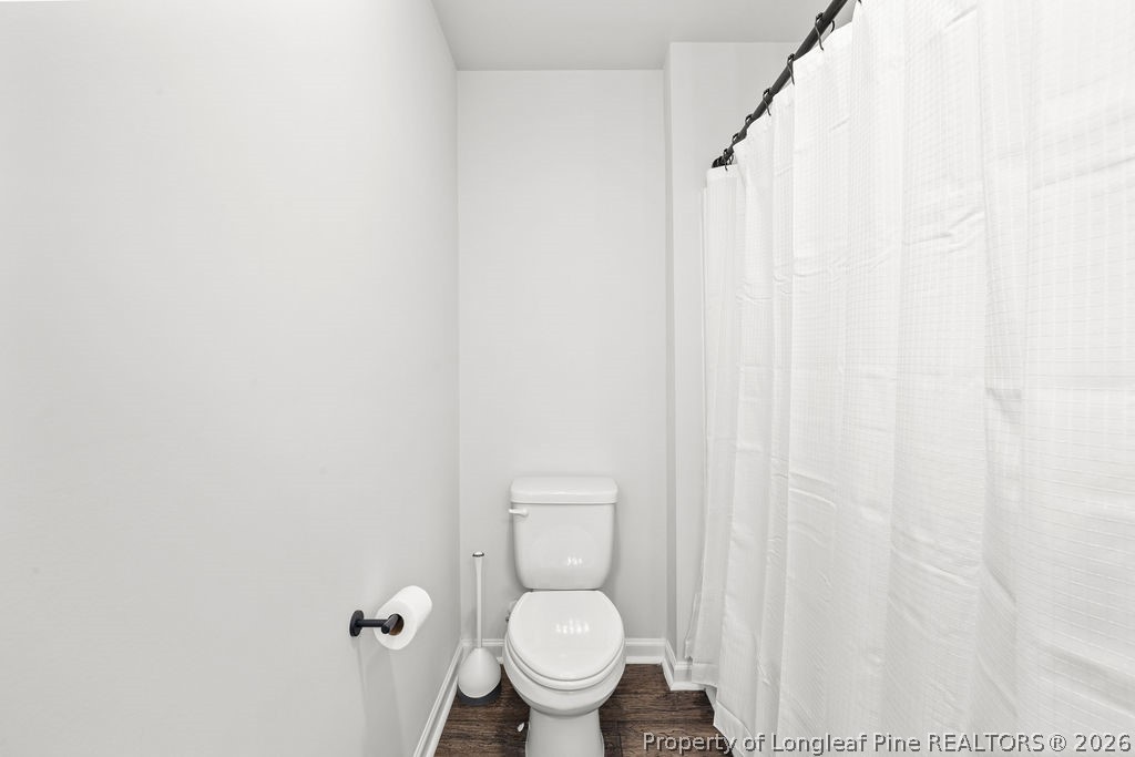 81 Merlin Court Godwin, NC 28344 - Photo 27 of 34 a white toilet sitting next to a shower curtain