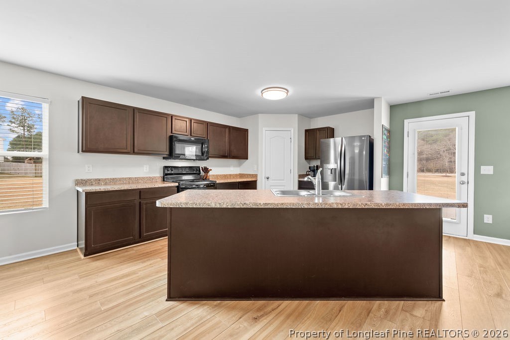 81 Merlin Court Godwin, NC 28344 - Photo 6 of 34 a kitchen with granite countertop a refrigerator and a stove top oven