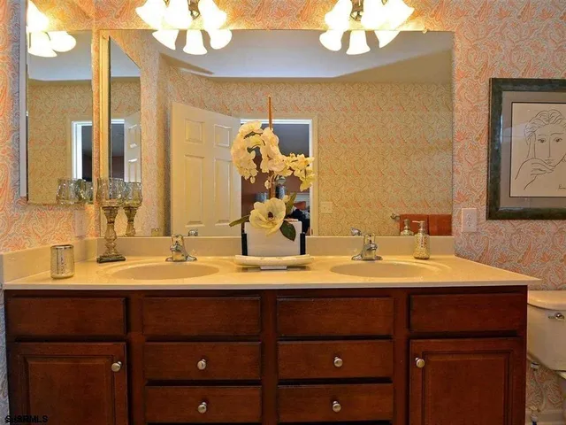 a bathroom with a sink vanity and a mirror