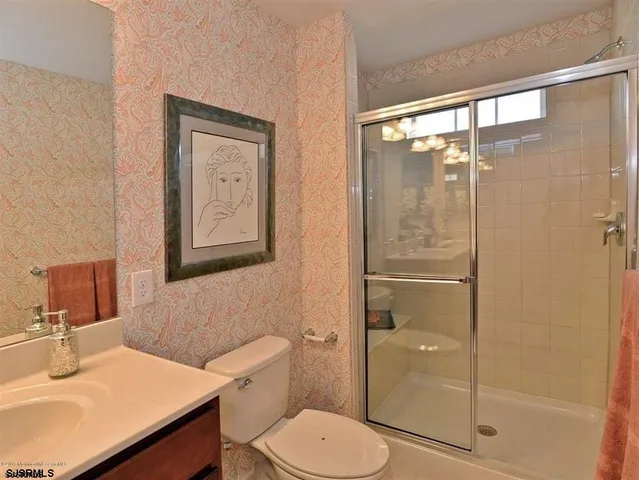 a bathroom with a toilet a sink and shower