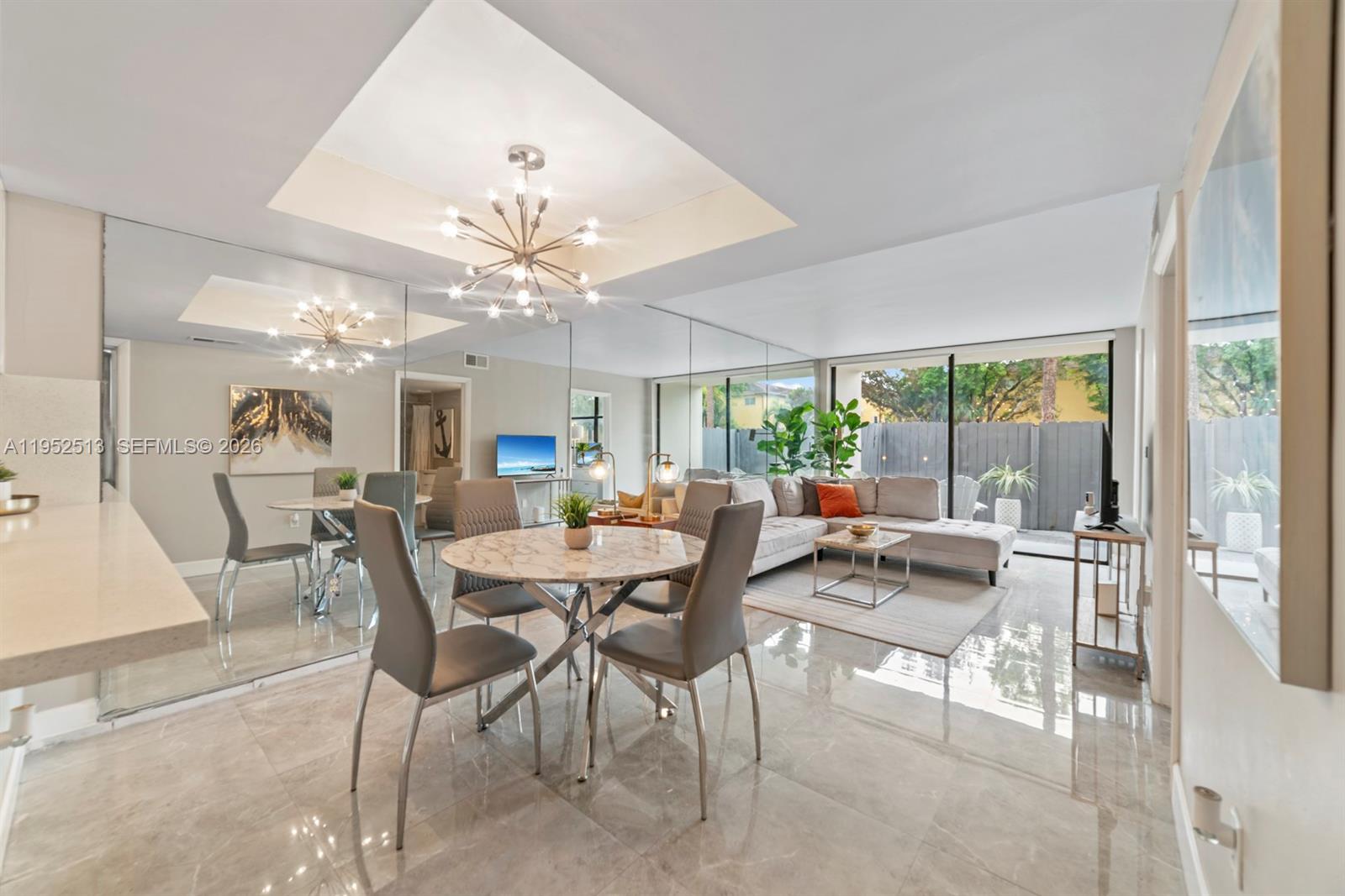 a view of a dining room with furniture wooden floor and chandelier