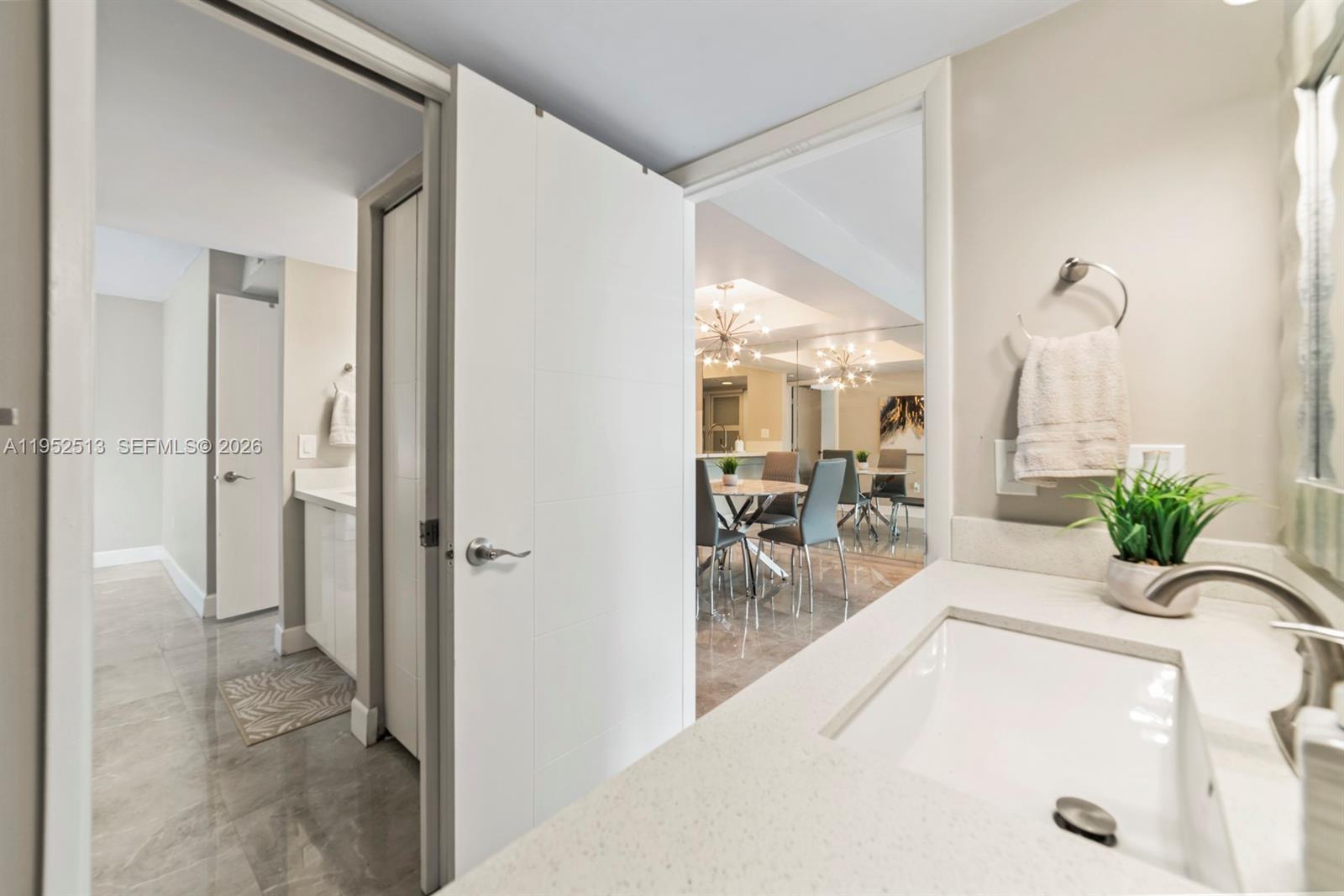 8002 Southwest 149th Avenue, Unit B118 Miami, FL 33193 - Photo 11 of 23 a view of a hallway with dining area and chandelier