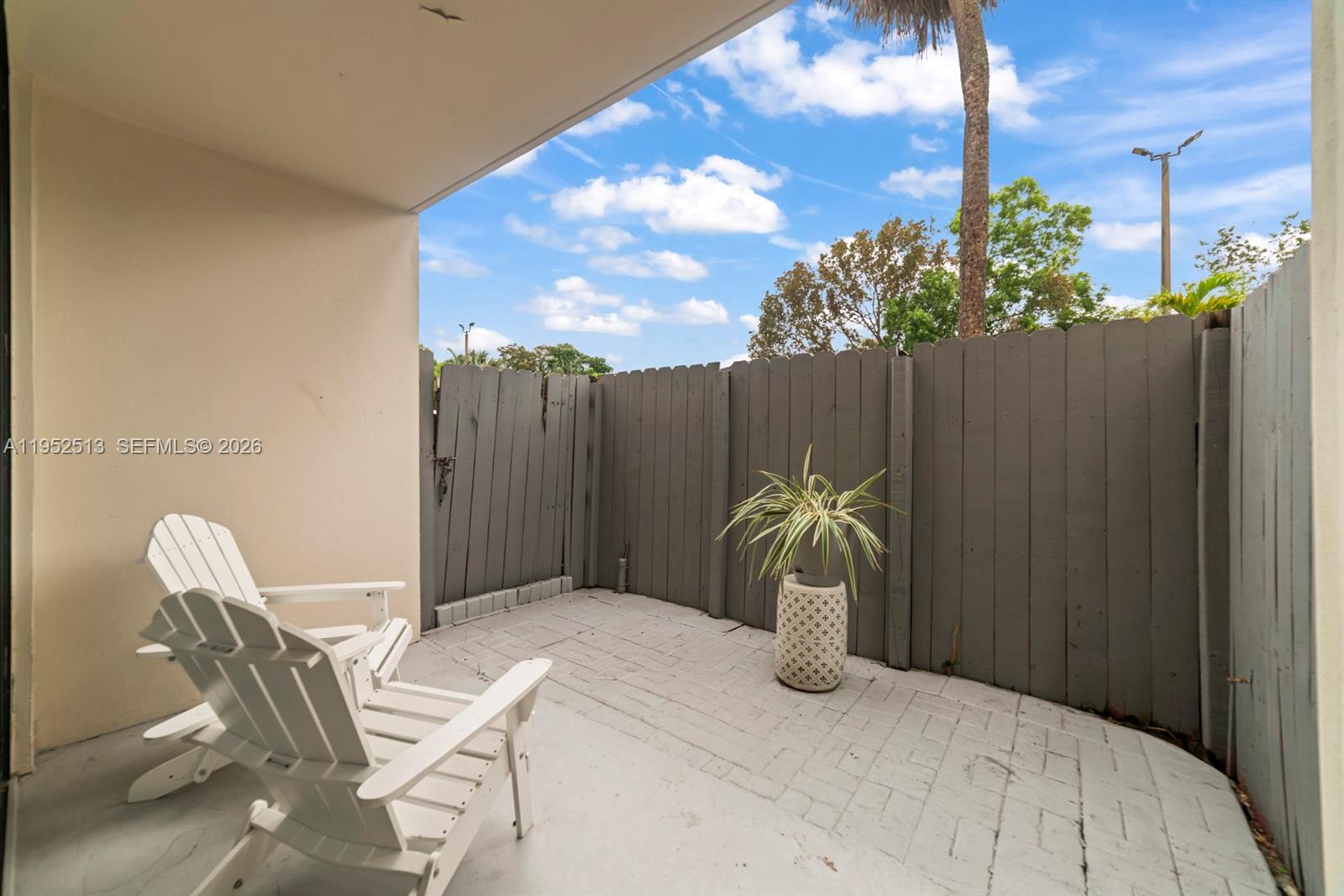 8002 Southwest 149th Avenue, Unit B118 Miami, FL 33193 - Photo 18 of 23 a bed sitting in a bedroom next to a yard