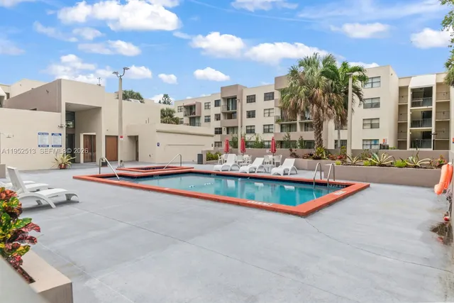 a swimming pool with outdoor seating and yard