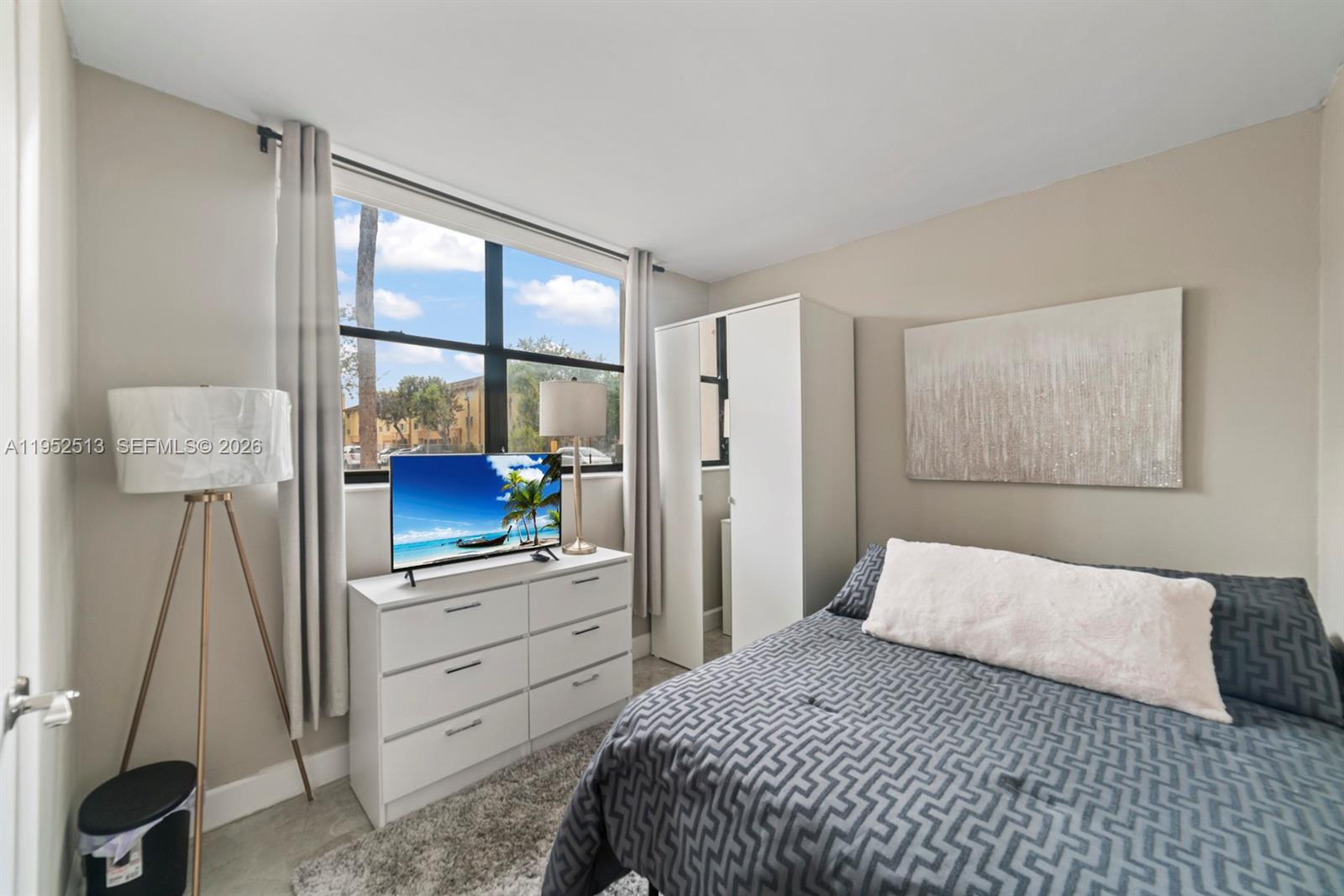 8002 Southwest 149th Avenue, Unit B118 Miami, FL 33193 - Photo 6 of 23 a bedroom with a bed and a large window