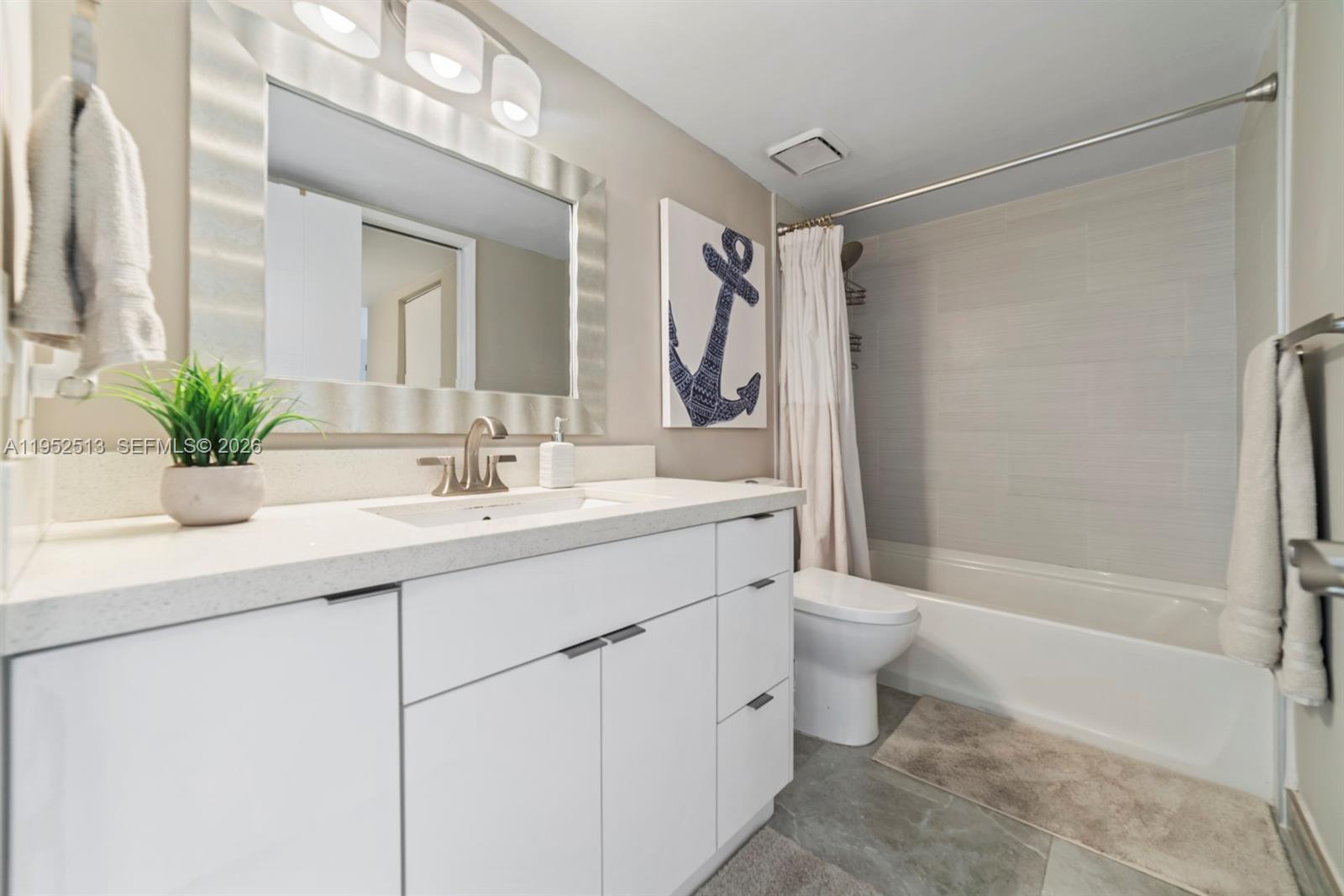 8002 Southwest 149th Avenue, Unit B118 Miami, FL 33193 - Photo 7 of 23 a bathroom with a double vanity sink toilet and shower