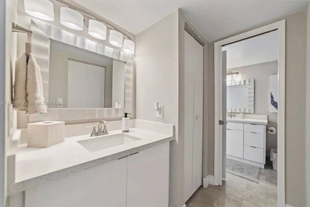 a bathroom with a double vanity sink mirror and