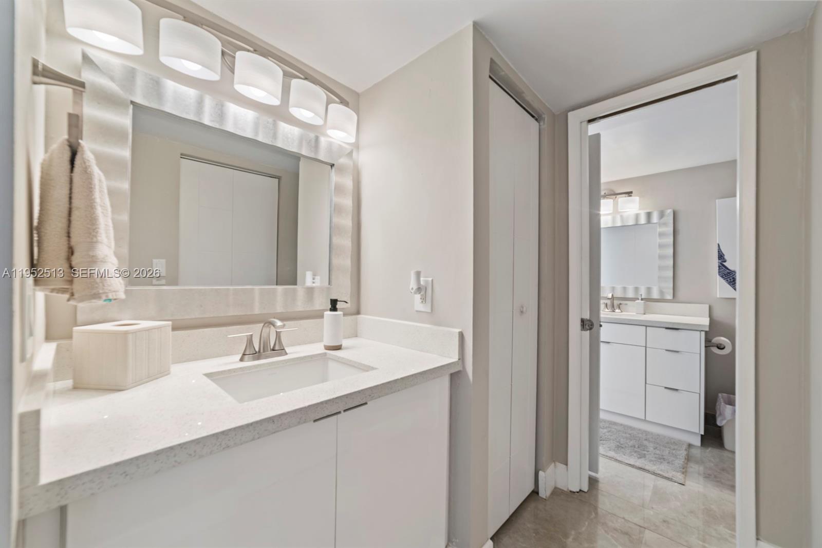 8002 Southwest 149th Avenue, Unit B118 Miami, FL 33193 - Photo 8 of 23 a bathroom with a double vanity sink mirror and