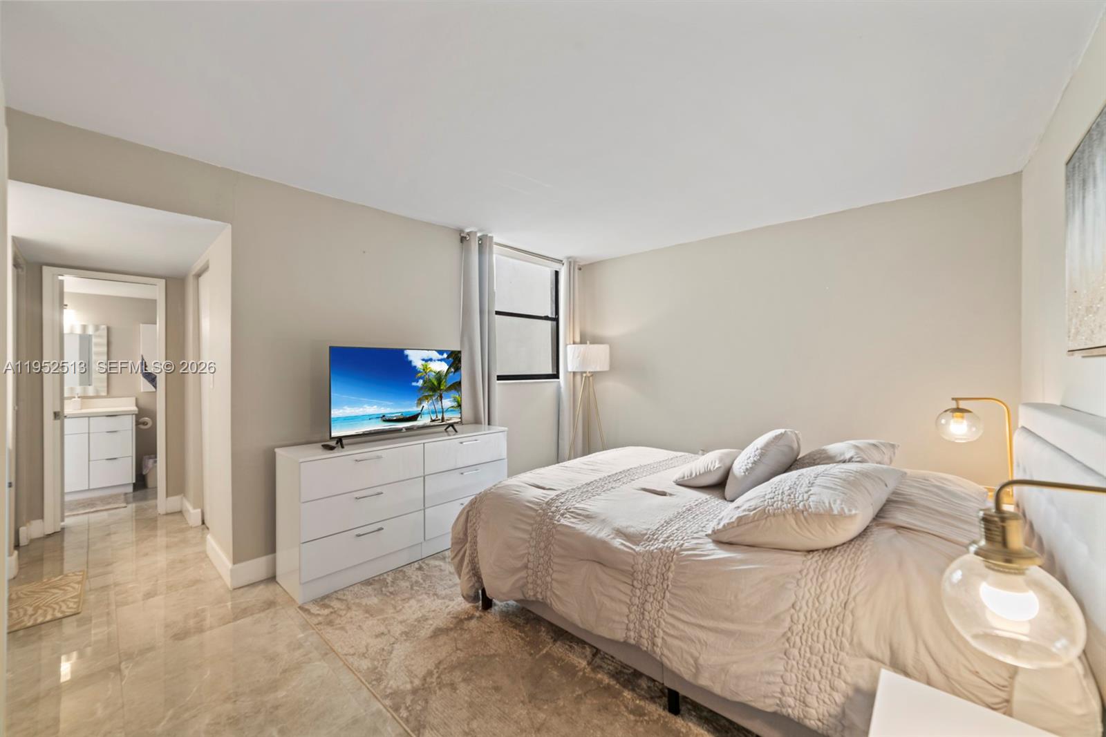 8002 Southwest 149th Avenue, Unit B118 Miami, FL 33193 - Photo 9 of 23 a bedroom with a bed and a flat screen tv