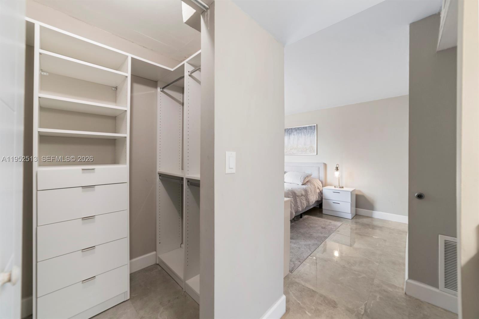 8002 Southwest 149th Avenue, Unit B118 Miami, FL 33193 - Photo 10 of 23 a view of walk in closet with clothes and shoes