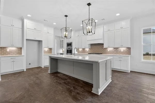 a view of a kitchen with wooden floor and windows