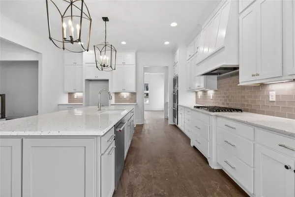 a view of a kitchen with a sink and cabinets