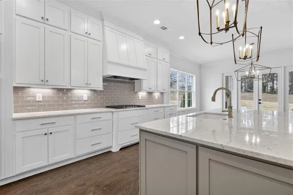 a view of a livingroom with a ceiling fan window and a kitchen