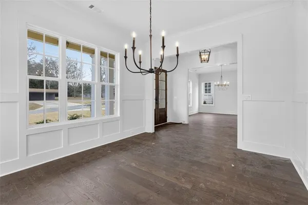 a view of kitchen with stainless steel appliances cabinets and center
