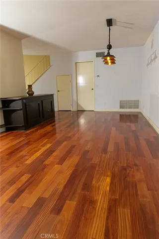 an empty room with a fireplace and windows