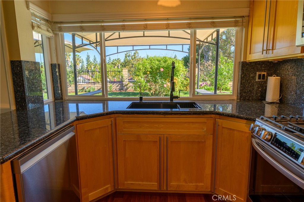 1202 Villanova Place Riverside, CA 92506 - Photo 8 of 59 a kitchen with stainless steel appliances granite countertop a refrigerator and a stove