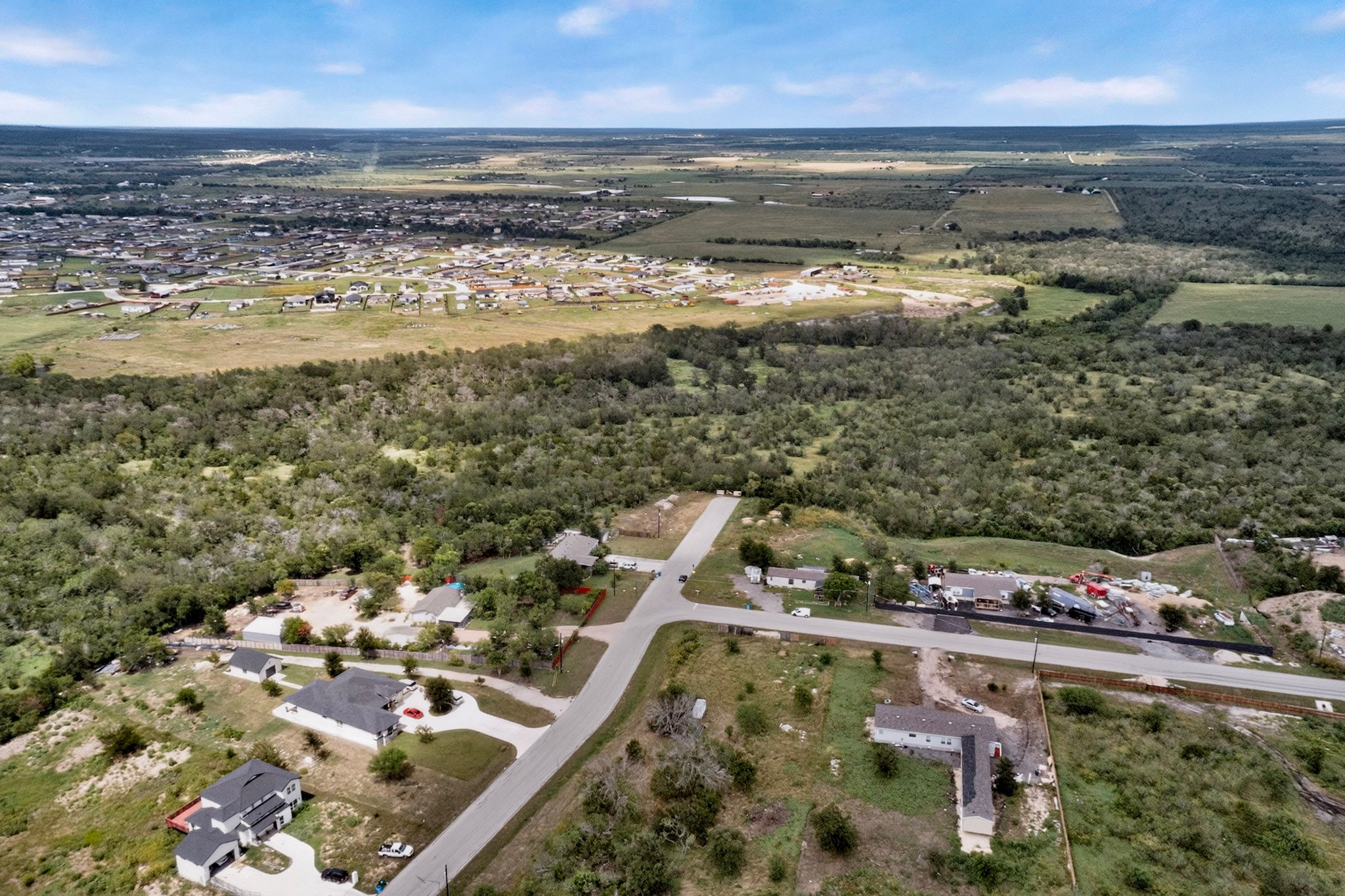 693 Santa Teresa Road Kyle, TX 78640 - Photo 7 of 20 Discover a vast, undeveloped acreage with scattered residences offering rural charm and potential.