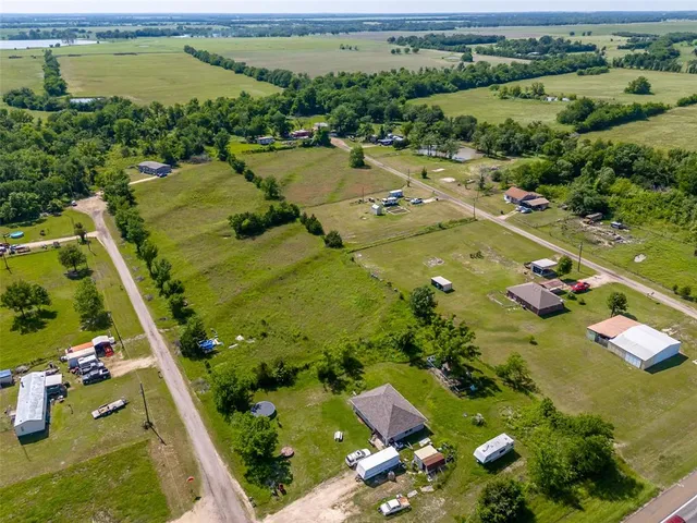 an aerial view of a residential houses with outdoor space