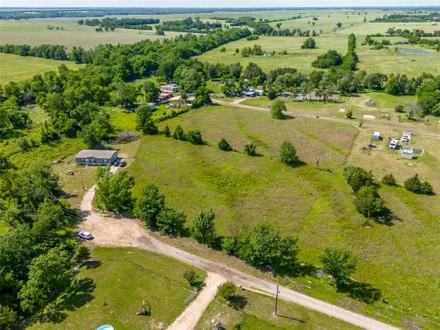 an aerial view of residential houses with outdoor space