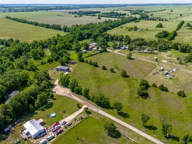 an aerial view of a residential houses with outdoor space