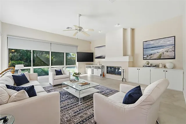 a view of a livingroom with furniture and a ceiling fan