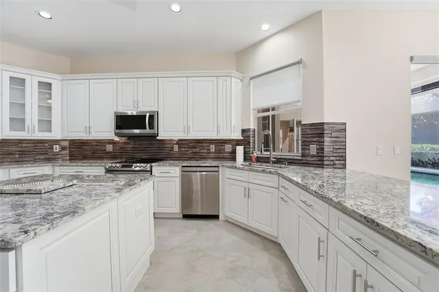 a view of an empty room with a fireplace and a ceiling fan