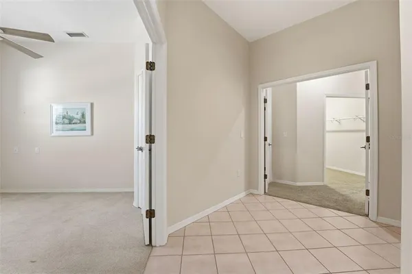 a spacious bathroom with a granite countertop sink mirror and a bathtub