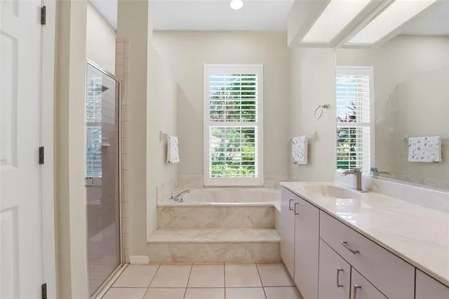 a living room with a bed furniture and a flat screen tv