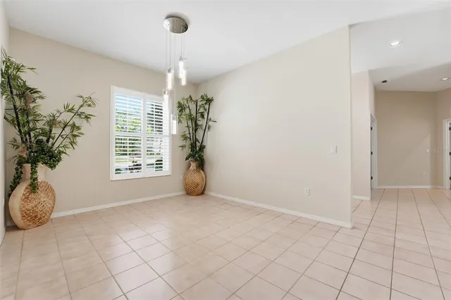 a view of a hallway with a chandelier fan and windows