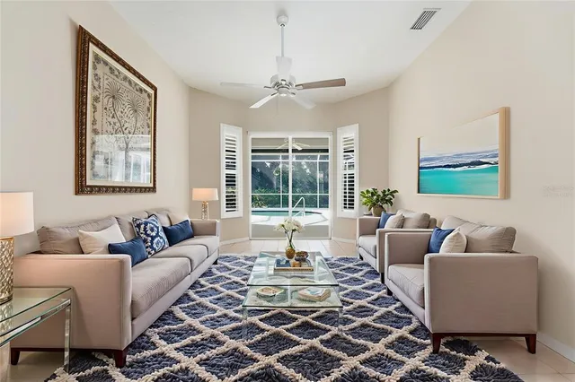 a view of an empty room with a fireplace and windows