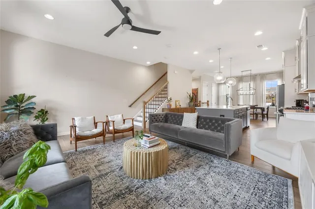 a living room with furniture and a chandelier