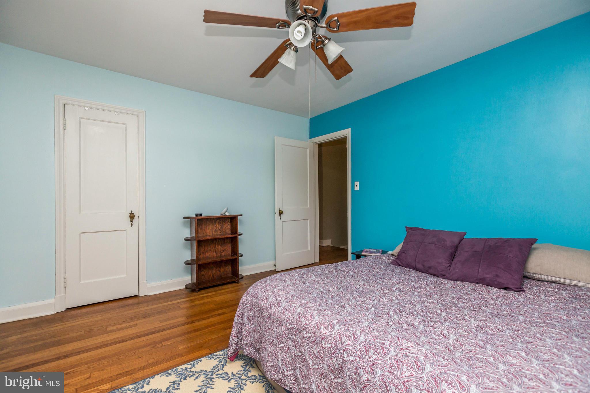 403 Overbrook Road Baltimore, MD 21212 - Photo 14 of 26 a bedroom with a bed and wooden floor