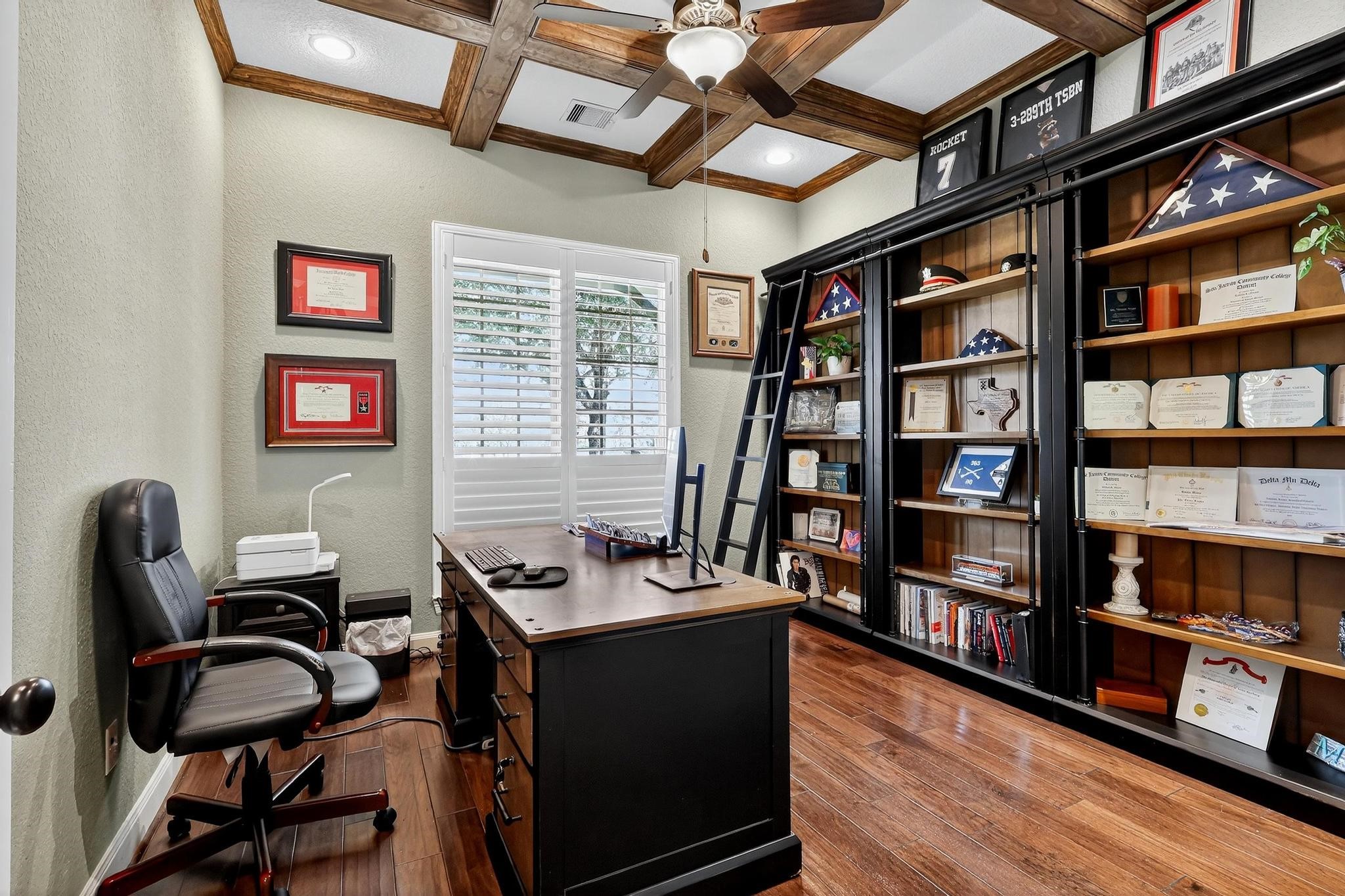 25803 Heritage Maple Drive Spring, TX 77389 - Photo 9 of 46 a view of a workspace with furniture and a book shelf
