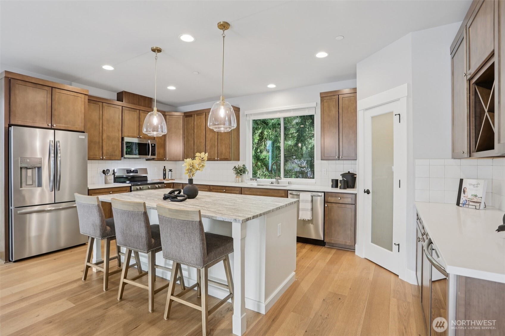 15 160th Place Southeast Bothell, WA 98012 - Photo 11 of 36 a kitchen with stainless steel appliances granite countertop a refrigerator a sink dishwasher a stove and white cabinets with wooden floor