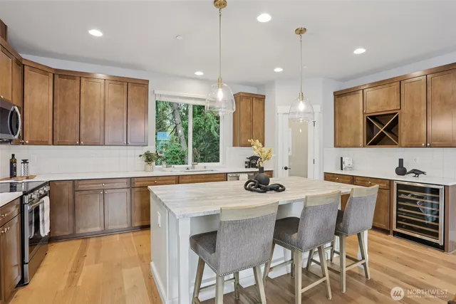 a kitchen with a sink cabinets and wooden floor