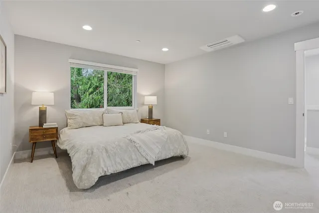 a bedroom with a bed and a lamp