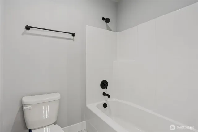 a bathroom with a toilet and a bathtub