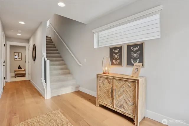 a view of entryway and hall with wooden floor