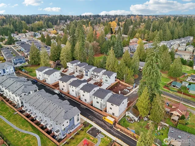 an aerial view of a residential apartment building with a yard
