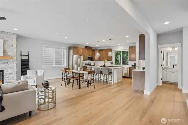 a living room with furniture and a dining table with kitchen view