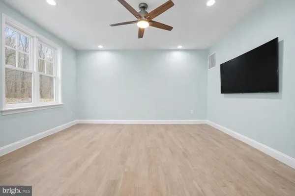 a spacious bathroom with a granite countertop sink mirror and shower